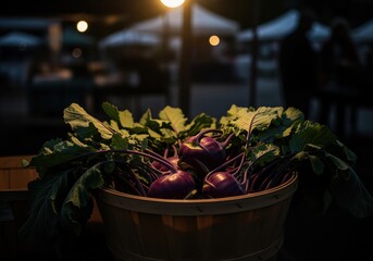 Fresh purple kohlrabi vegetables in a basket at a dark outdoor farmer market.
