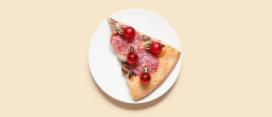 Plate with piece of tasty pizza and Christmas balls on color background