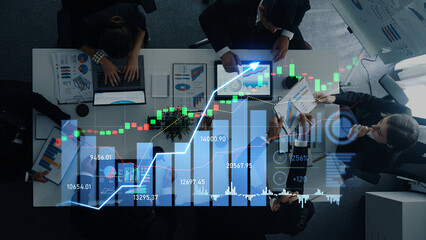 Business professionals engage in a collaborative meeting, analyzing financial data through charts and graphs to strategize and make informed decisions in a modern workspace. Scalp