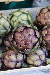 Obraz premium Fresh organic artichokes displayed for sale in produce market vertical photo