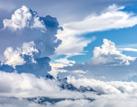A scenic photo capturing expansive cumulus clouds with sun-kissed edges partially obscuring mountain peaks against a vibrant blue sky - Powered by Adobe
