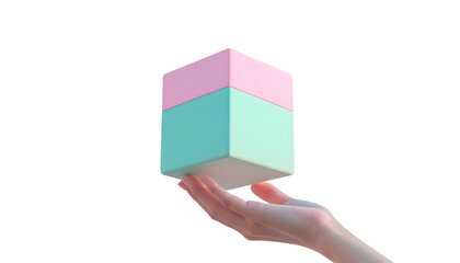Hand holding a pastel, two-toned pink and turquoise cube, isolated on a black background with even lighting
