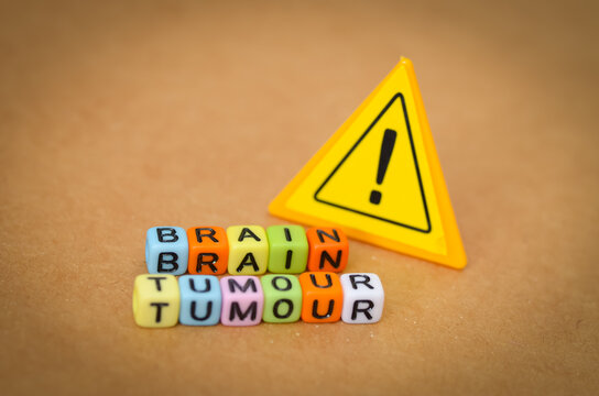 Warning: Brain Tumour. A stark visual featuring text and a yellow warning sign, highlighting the serious medical diagnosis and health risk.