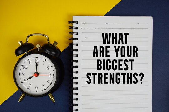 What Are Your Biggest Strengths? text written on notepad with alarm clock on yellow background