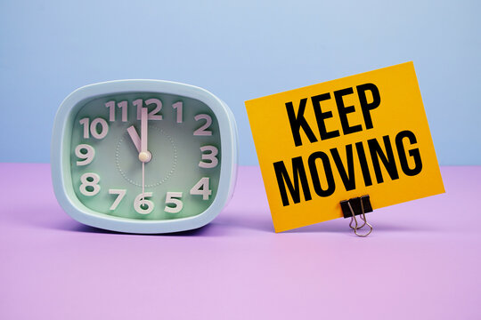 Keep Moving text and alarm clock on blue and purple background