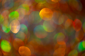 Glitter background with shiny golden sparkles. Glitter bokeh lights. Festive glowing backdrop with...