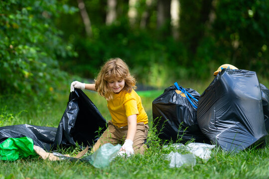 Child picking plastic trash for cleaning the nature. kid Clean up garbage outdoor. Ecology concept. Environment Day. Save earth. Recycling bin garbage. Ecology. Environmental care. Eco kid.