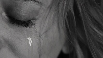 A woman is crying, sad, loss, hopeless about everything, black and white, sad footage