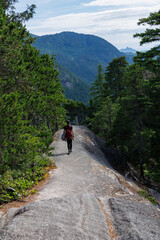 Obraz premium Hiking in the mountains. Woman is on the trail. 