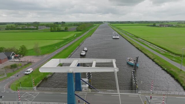 Nadir (top-down) shot of a closed bascule bridge spanning a canal; protective fenders and abutments visible.