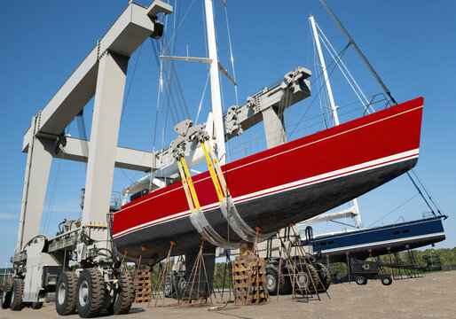Large Boat Lift:  An industrial boat lift holds the hull of a large sailing yacht at a New England shipyard.
