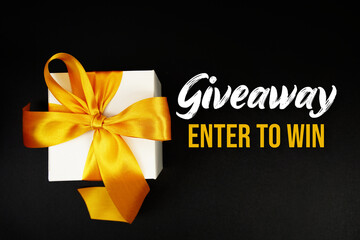 Giveaway Enter to Win text with gift box present on black background