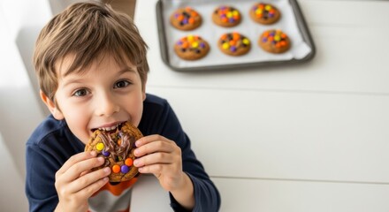 Sweet Treats: A young boy, caught in a moment of pure bliss, takes a delicious bite of a colorful cookie adorned with candies, a symbol of childhood joy and the simple pleasure of indulgence. 