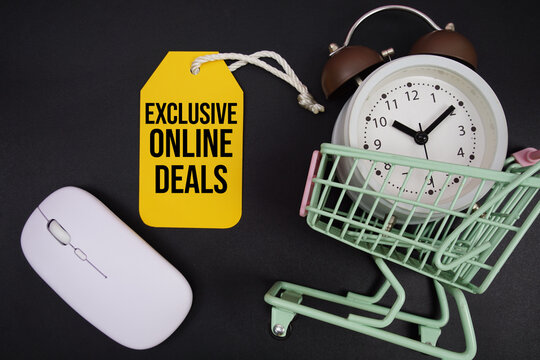 Mini Trolley Shopping Cart with alarm clock and price tag with message "Exclusive Online Deals" and wireless mouse on black background - Powered by Adobe