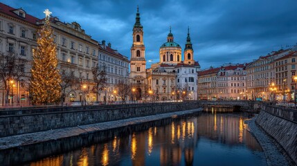 Fototapeta premium Prague Cityscape at Dusk Featuring St. Nicholas Church and Festive Christmas Tree Along the Water