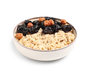 Bowl of tasty oatmeal with prunes and hazelnuts on white background
