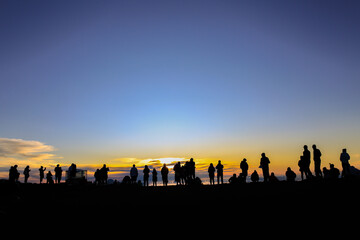 Sunset. "Puʻuʻulaʻula" (Red Hill) is the summit of Haleakalā on Maui, Hawaii. A sea of clouds is an overcast layer of stratocumulus clouds. Haleakalā National Park