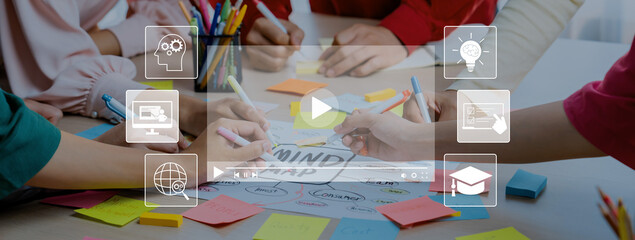 A diverse group engages in a collaborative brainstorming session, using colorful sticky notes and...