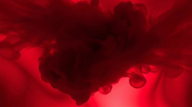 Abstract red fluid dynamics with dark amorphous shapes spreading.