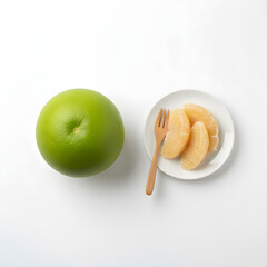 Pomelo Fruit Flat lay contrast between a whole green fruit and pinkish peeled segments with a fork