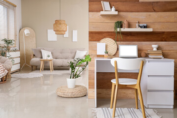 Interior of studio apartment with workplace, sofa and plants