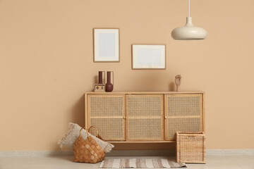 Interior of room with commode, frames and lamp