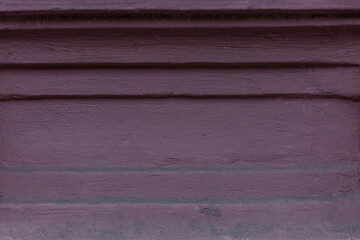 An old burgundy concrete wall of a house. Construction and renovation. Background. Space for text.