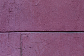 An old burgundy concrete wall of a house. Construction and renovation. Background. Space for text.