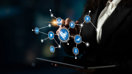 A businesswoman engages with a digital interface, showcasing various icons representing e-commerce and technology in a modern workspace setting. Tessel