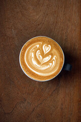 a cup of latte art coffee on wooden background                           