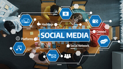 A diverse team engages in collaborative discussions on social media strategies, surrounded by digital icons symbolizing connectivity and interaction in a modern workspace. Amity