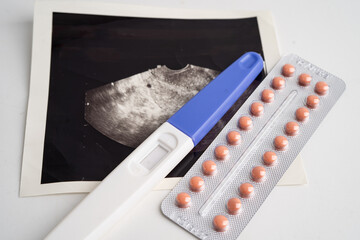 Pregnancy test with ultrasound scan photo of fetus, maternity, childbirth, birth control.