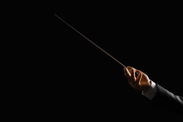 Male conductor's hand on black background