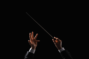 Male conductor's hands on black background