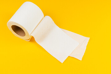 Roll of paper on bright yellow background for cleaning and hygiene tasks