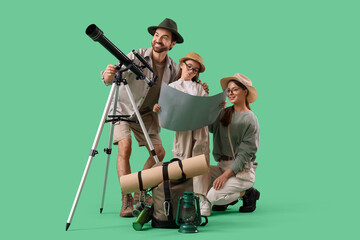 Family of adventurers with map and telescope on green background