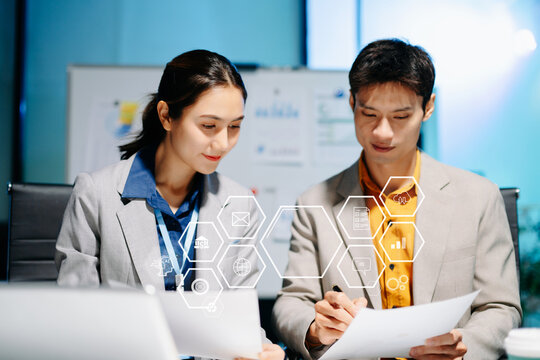 business team working late with AI digital interfaces, data analysis, and fintech tools. Perfect for concepts of technology, innovation, smart office