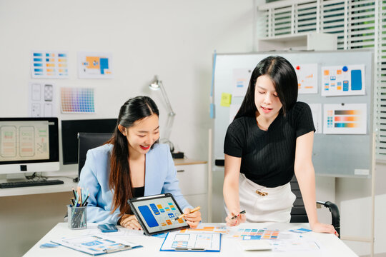 UX UI designers collaborating on mobile app wireframes, showcasing teamwork, creative planning, and modern startup design - Powered by Adobe
