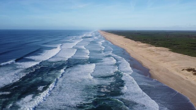 drone circles over a awesome beach with waves, atlantic coast of france