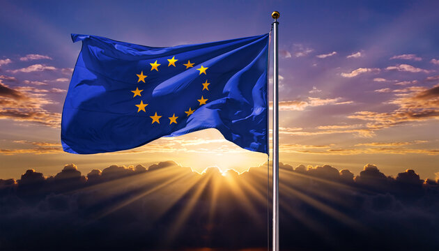 Flag of the European Union Waving on a Pole Against a Dramatic Sunrise Background