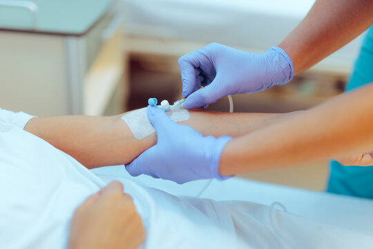 Medical Professional Preparing an IV for Patient Care in a Clinic. Nurse making sure the tubing is done professionally in high standards 
 - Powered by Adobe