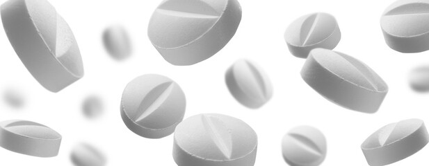 White round tablets levitate on a white background