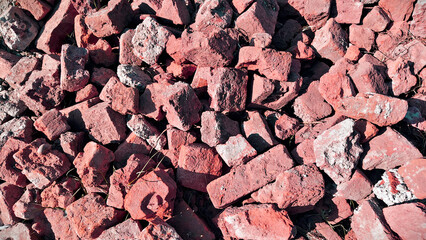 Broken red rock and gravel texture with natural rugged earth detail ideal for backgrounds, geology references and design elements