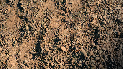 Rough dry soil texture with natural earthy surface and organic ground detail ideal for backgrounds, geology and design projects
