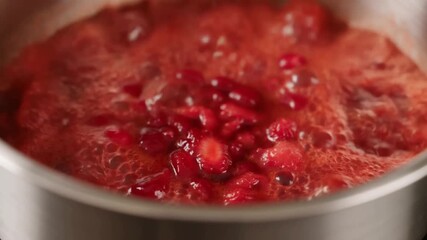 Fresh, red cranberry sauce simmering gently in a steel pot, offering a tantalizing glimpse of a homemade, festive treat Stock Video