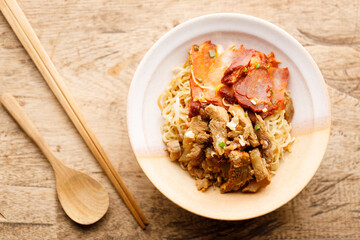Egg Noodles with meat in bowl with chopsticks