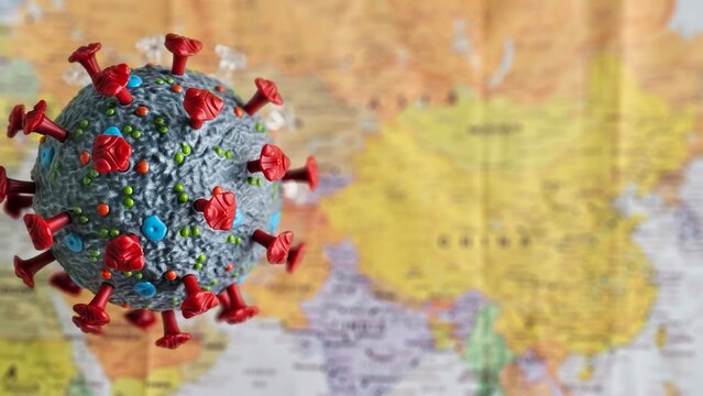 Virus model displayed over a map of Asia, highlighting global health challenges and the importance