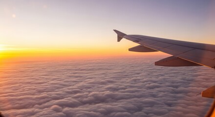 Fototapeta premium Airplane wing over sunset clouds with vibrant sky