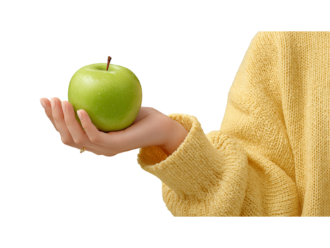 Female hand holding apple in yellow sweater