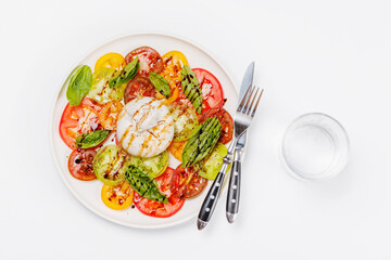 Fresh burrata served on slices of colorful tomatoes